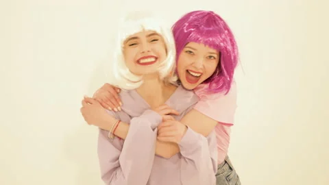 Two young cute beautiful smiling hipster girls Stock Footage 142213255