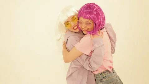 Two young cute beautiful smiling hipster girls in trendy summer clothes Stock Footage 142214873