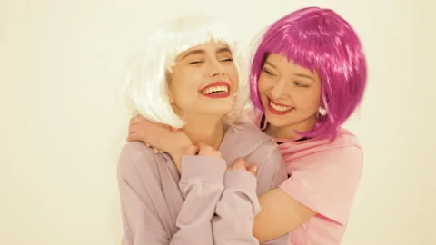 Two young cute beautiful smiling hipster girls in trendy summer clothes Stock Footage 142214899