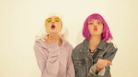 Two young cute beautiful smiling hipster girls in trendy summer clothes Stock Footage 142215643