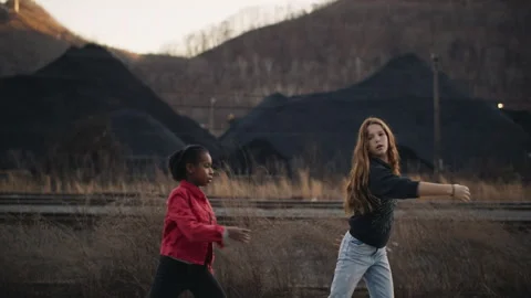 Two young diverse friends dancing together outdoors Vídeo Stock 334098386