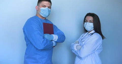 Two young doctors in lab coats a nurse and a doctor Stock Footage 107903849