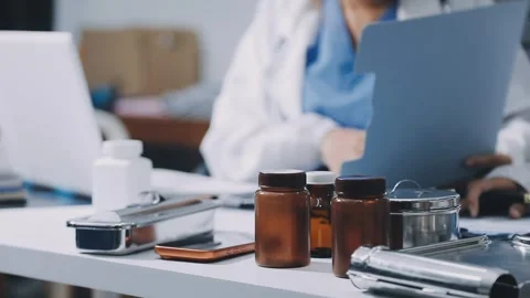 Two young doctors middle-eastern man and woman looking at x-ray scan of pat.. Stock Footage 337286038