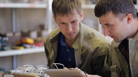 Two young electricians solve the problem of electricity connection Video stock 74230351