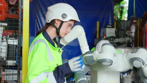 Two young engineer checking and maintenance machine robot arms technology i.. Stock Footage 237875013