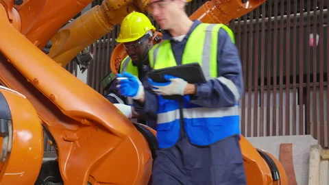 Two young engineer man checking and maintenance machine robot arms technolo.. 스톡 동영상 235542794