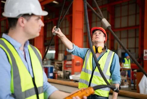 Two young engineers Testing and checking the operation of the semi gantry ... Stock Photos