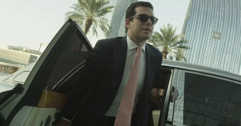 Two young executives exit a limo in slow motion Stock Footage 73254142