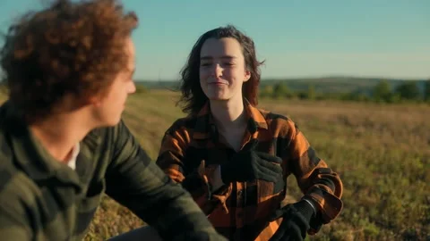 Two young farmers talking and connecting in the rural open countryside field Stock Footage 317084150