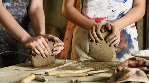 Two young female art students kneading clay for sculpting Stock Footage 55040395