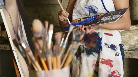 Two young female art students helping eachother and laughing Stock Footage 55310461