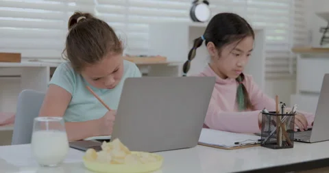 Two Young Female Students Concentrating On Digital Learning And Writing Ass.. Stock Footage 336248760