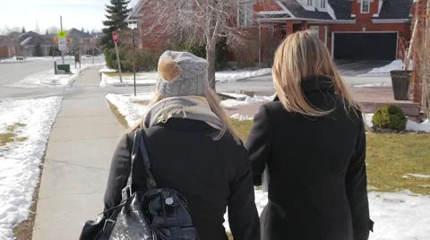 Two Young Females Walking Up To An Intersection Talking In Winter Stock Footage 62822833