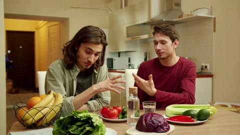 Two young friends are talking about vegetables and smiling Stock Footage 159365224