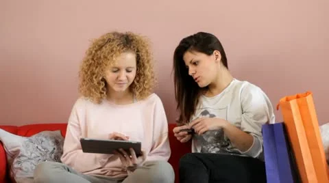 Two young friends making online shopping Stock Footage 22238411