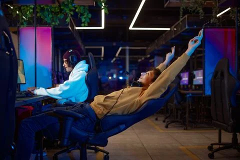 Two young gamers having fun in game club Stock Photos