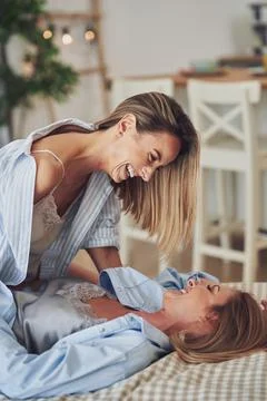 Two young girlfriends on the bed Stock Photos