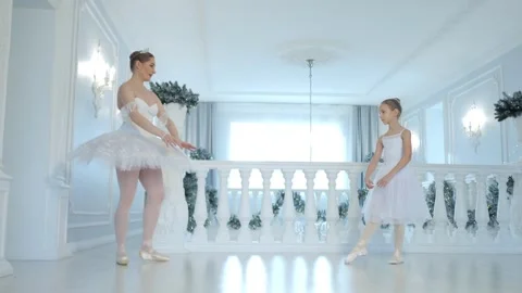 Two young girls are dancing in a ballroom Stock Footage 301940597
