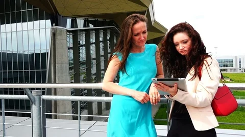 Two young girls are looking at the tablet computer Stock Footage 80237627