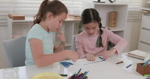 Two Young Girls Collaborating On Art Project With Crayons At Home Medium Shot Stock Footage 337086002