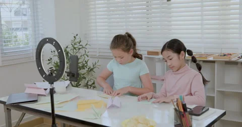 Two Young Girls Creating Paper Origami Animals For Social Media Tutorial Me.. Vídeo Stock 336249733