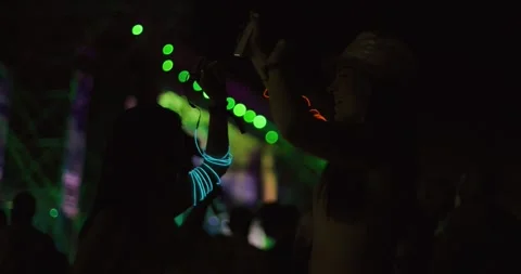 Two young girls dancing in crowd in front of stage. Low light video. Slow motion Stock Footage 313654909