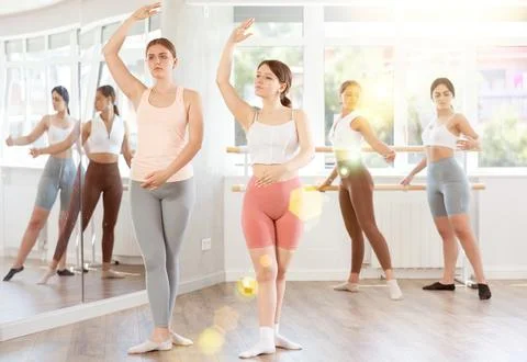 Two young girls demonstrating basic ballet positions 스톡 사진