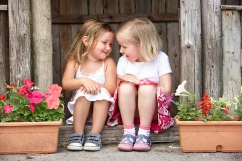 Two Young Girls Playing in Wooden House Stock Photos