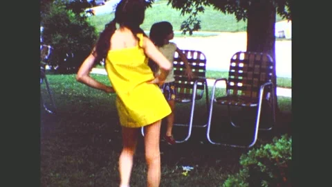 Two Young Girls Sauntering Over To Lawn Chairs Then Sitting And Smiling Stock-Footage 170719945