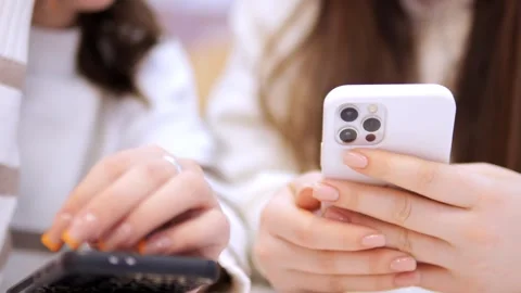 Two young girls using mobile phones while sitting at the cafe indoors mall. Two Stock Footage 266816839