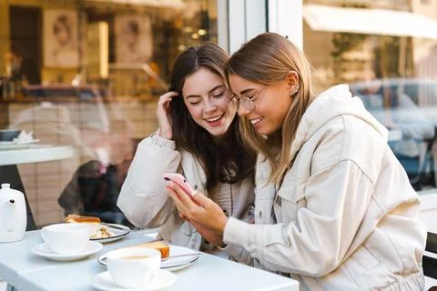 Two young girls using smart phone Stock Photos