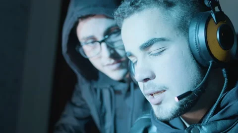 Two young guys actively discussing something while hacking Stock Footage 181825761