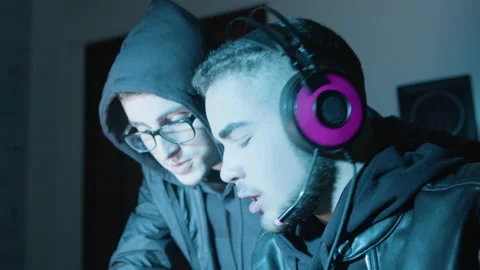 Two young guys actively discussing something while hacking Stock Footage 181841635