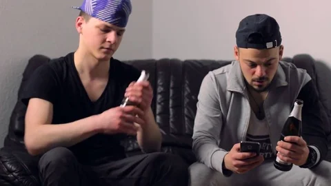 Two young guys drinking beer and pretending to do sport only for a selfie Stock Footage 72351417