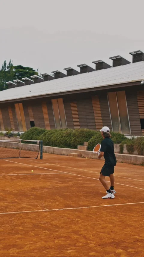 Two young guys playing big tennis on the outdoors court Stock Footage 328795918