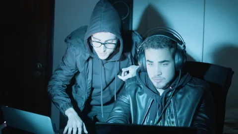 Two young guys talking and discussing things while hacking Stock Footage 181823563