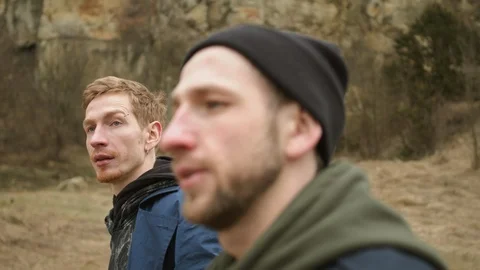 Two Young Guys Walking On The Road In Nature. They Joke And Laugh. Stock Footage 125760013