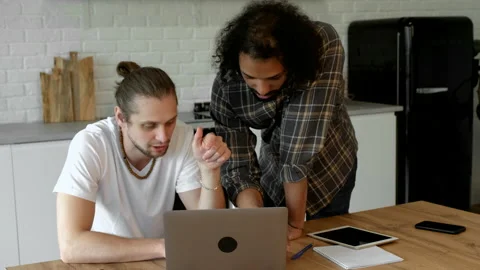 Two young guys work at home, use it in the summer and take notes Video stock 171542835