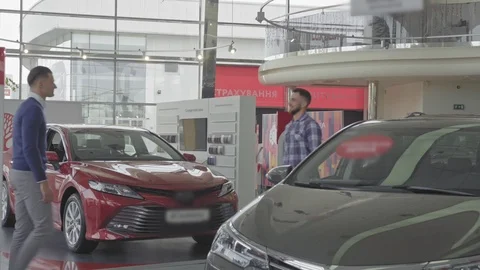 Two young handsome men shaking hand after car purchase. Stock-Footage 99772909