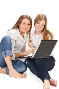 Two young happy student girl work on laptop computer isolated on white two... Stock Photos
