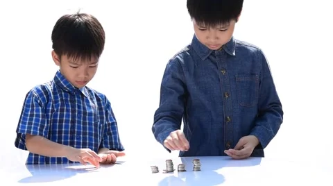 Two Young happy Thai boy build a tower by a coin 库存影片 68810928