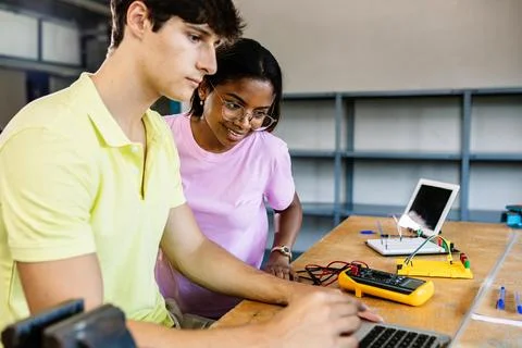 Two young high school students learning together at technology class Foto stock