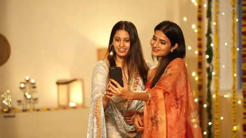 Two young Indian girls using a mobile: video call,during diwali Stock-Footage 252591084