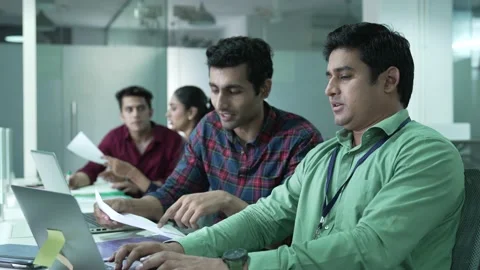 Two young Indian man holding papers pay domestic bills online on laptop. Видео 170126510
