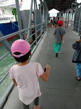 Two young kid with face mask during pandemic taking ferry ride Stock Photos