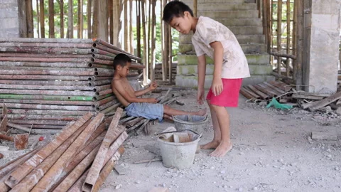 Two young laborers mixing cement and assisting construction work indoors, repres Stock Footage 336951394