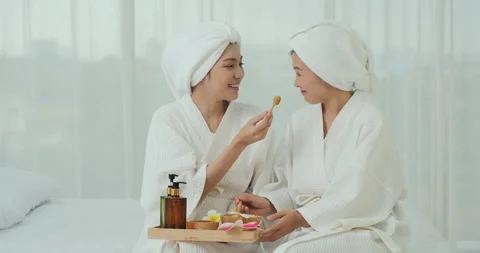 Two young lady wearing bathrobe at home. 스톡 동영상 141650489
