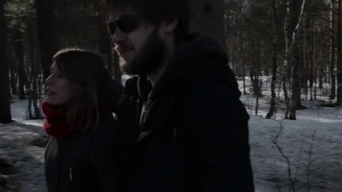 Two young lovers walk along the evening forest Stock Footage 76555100