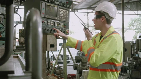 Two young maintenance man in uniform checking on machine and calling with rad Stock Footage 140117424