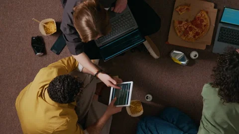 Two Young Male Developers Discussing Programming Code Sitting on Floor Stock Footage 312458672